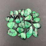 Green and black marbled stones on a gray background