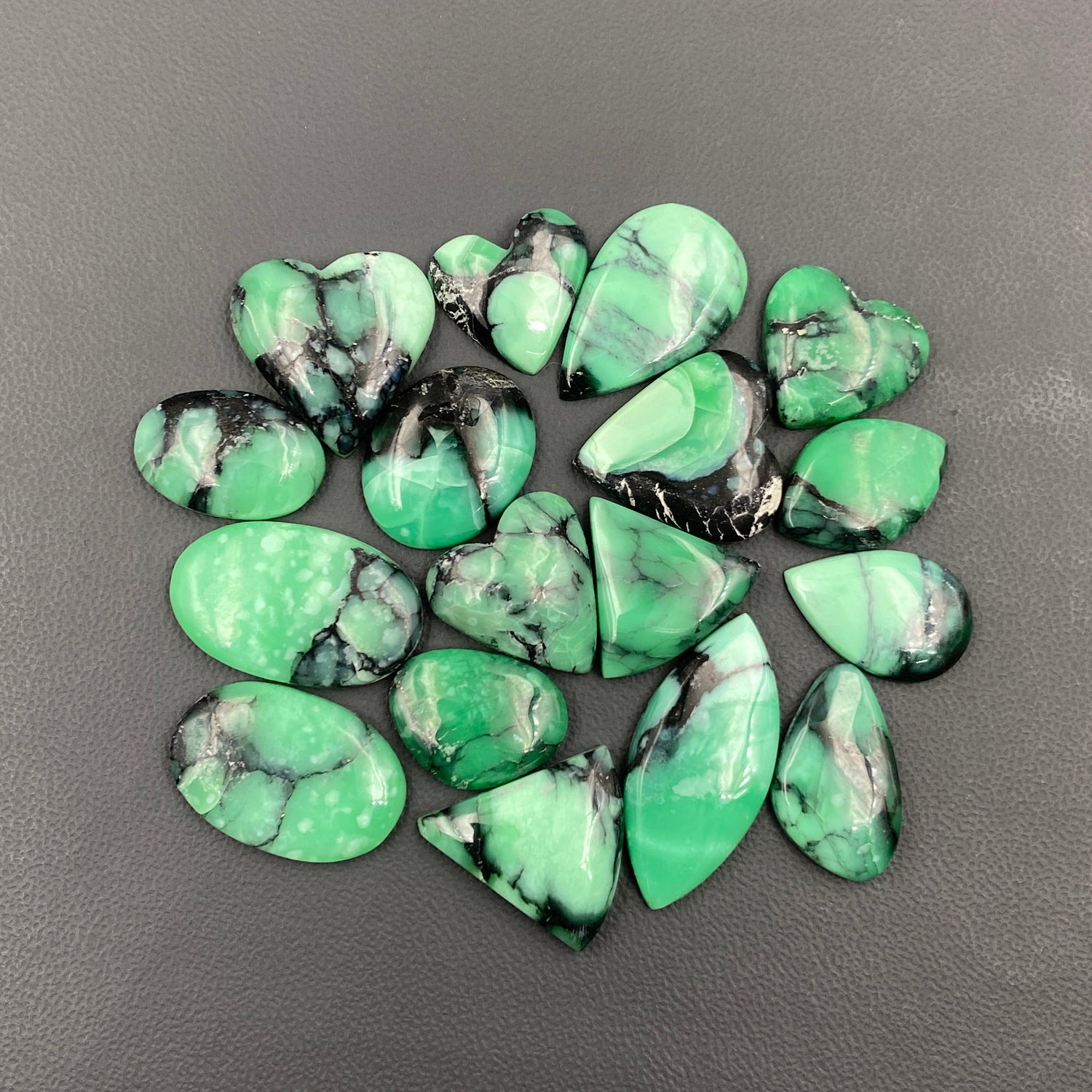 Green and black marbled stones on a gray background